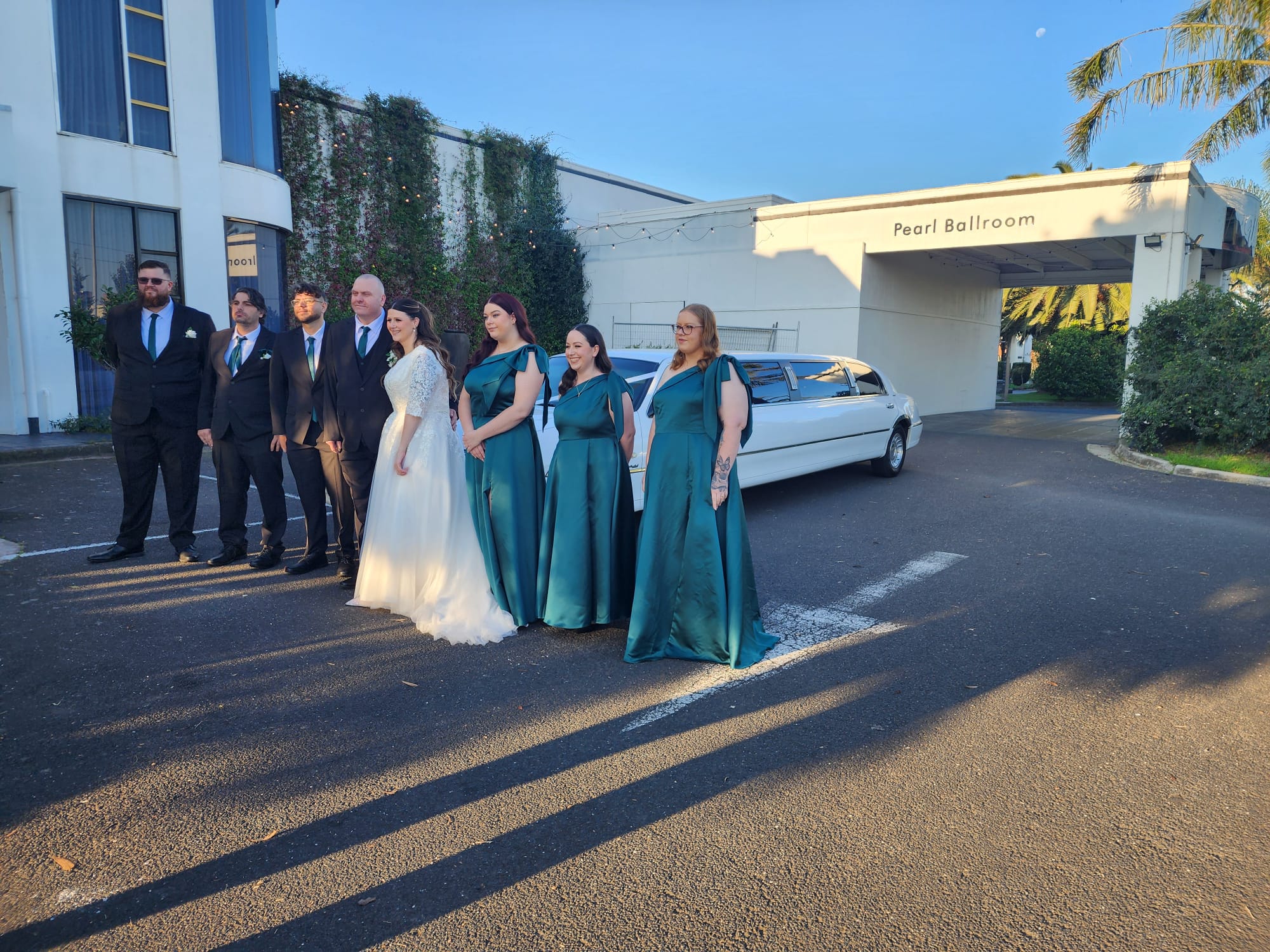 Wedding party beside Auslink Limousines white stretch limousine at a Keilor wedding